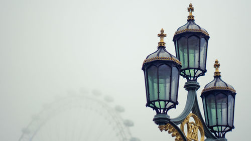 Low angle view of street light against building