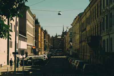 Street amidst buildings in city against sky