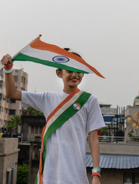 Cute indian girl kid waving indian flag celebrating indian independence day showing patriotism. 