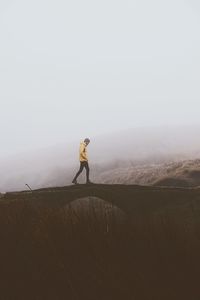 Full length of man standing on land against sky