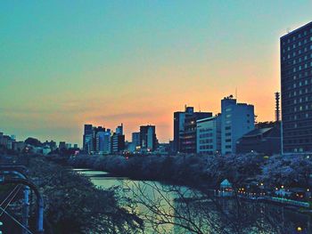 Buildings in city at sunset