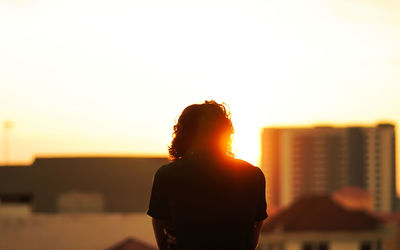 Silhouette man standing against sky during sunset