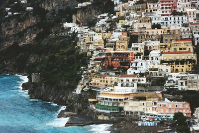 Buildings by sea in town