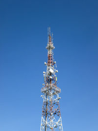 Telecommunication signal radio tower metal construction with clear blue skies background