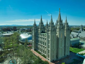 High angle view of buildings against blue sky