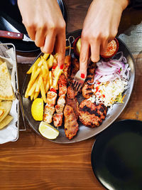 Midsection of man having food on table