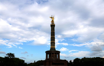 Low angle view of statue against cloudy sky