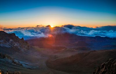 Scenic view of mountains against sky during sunrise