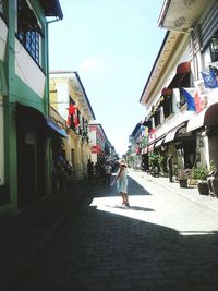 Woman walking on road in city