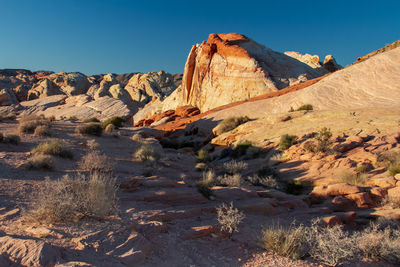 Rock formations in mountains against clear sky