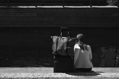 Rear view of women with umbrella walking in city