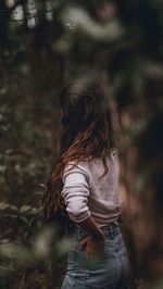 Rear view of woman standing on field