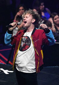 Young man dancing at music concert