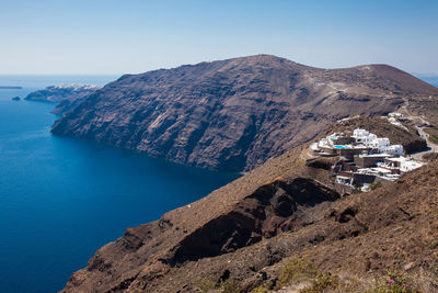 Panoramic view of sea and mountains against clear blue sky