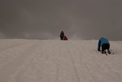 Woman standing on snow covered landscape