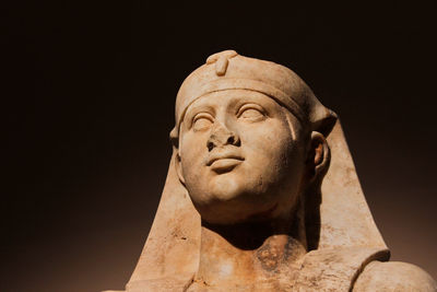 Head shot of a statue of egyptian-roman god osiris in low-key lightning