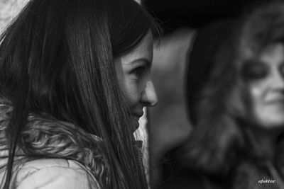 Close-up portrait of young woman looking away outdoors