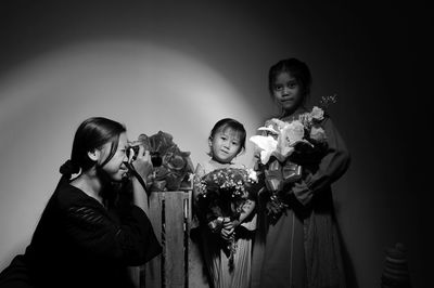 Family standing against wall