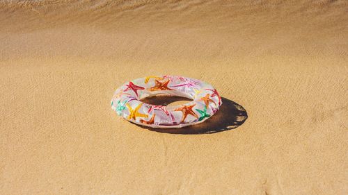High angle view of cake on sand at beach