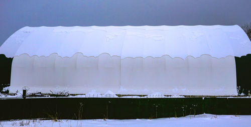 Frozen landscape against sky