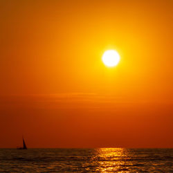 Scenic view of sea against orange sky