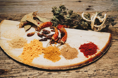 Spices and red chili peppers on table