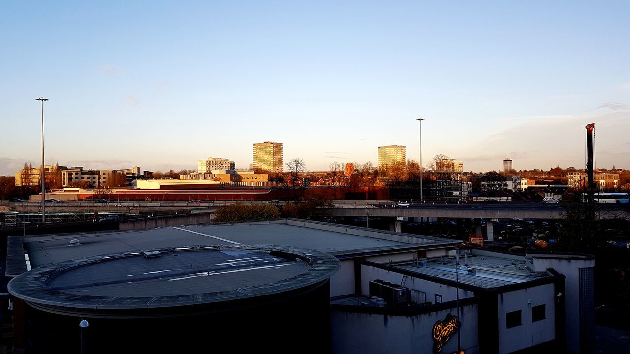 architecture, built structure, building exterior, city, transportation, no people, cityscape, sky, outdoors, sunset, skyscraper, nature, day, snow, urban skyline