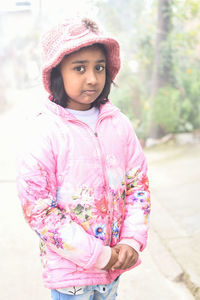 Portrait of cute girl standing on road