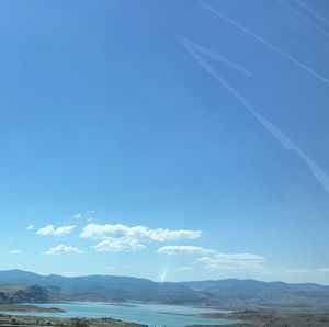 Scenic view of landscape against blue sky