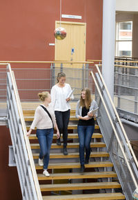 Three university student on stairs