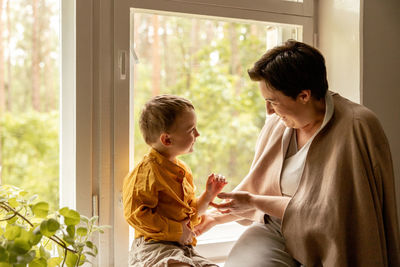 Happy grandmother and grandson enjoy time together. positive middle age woman