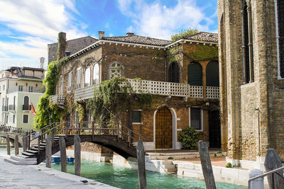 Arch bridge over canal against buildings in city