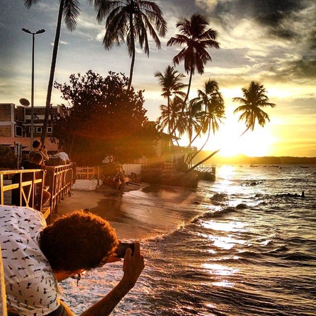 sunset, water, palm tree, sea, sky, tree, nautical vessel, beach, boat, transportation, mode of transport, horizon over water, nature, beauty in nature, scenics, tranquility, silhouette, sun, cloud - sky, tranquil scene