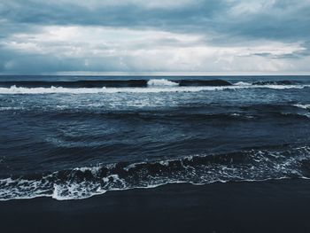 Scenic view of sea against cloudy sky