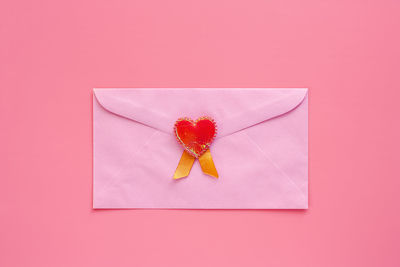 High angle view of pink flower on red background