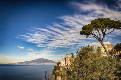 Vico equense's cathedral and the vesuvius in the background. italy