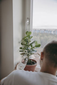 Woman watering potted plants