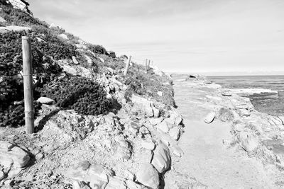 Scenic view of rocks on beach against sky