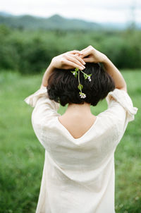 Rear view of woman holding flower