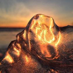 Close-up of water on beach during sunset