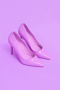Pink patent leather shoes on a pink background. pastel colours trends