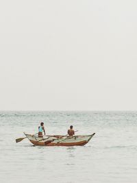 People in boat on beach