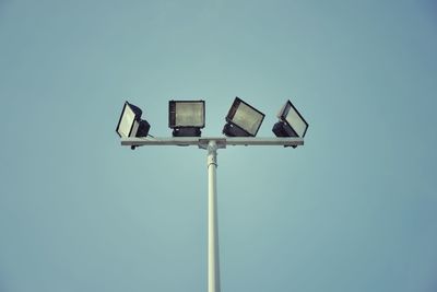 Low angle view of street light against blue sky