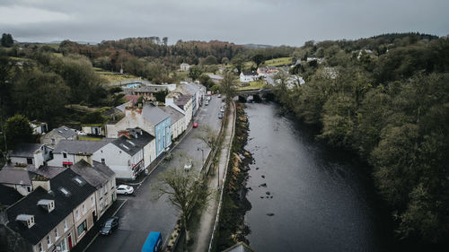 High angle view of river by city against sky