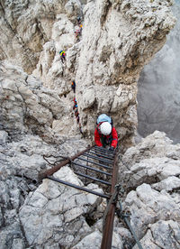 High angle view of man climbing on rock