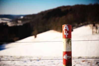 Close-up of information sign against clear sky