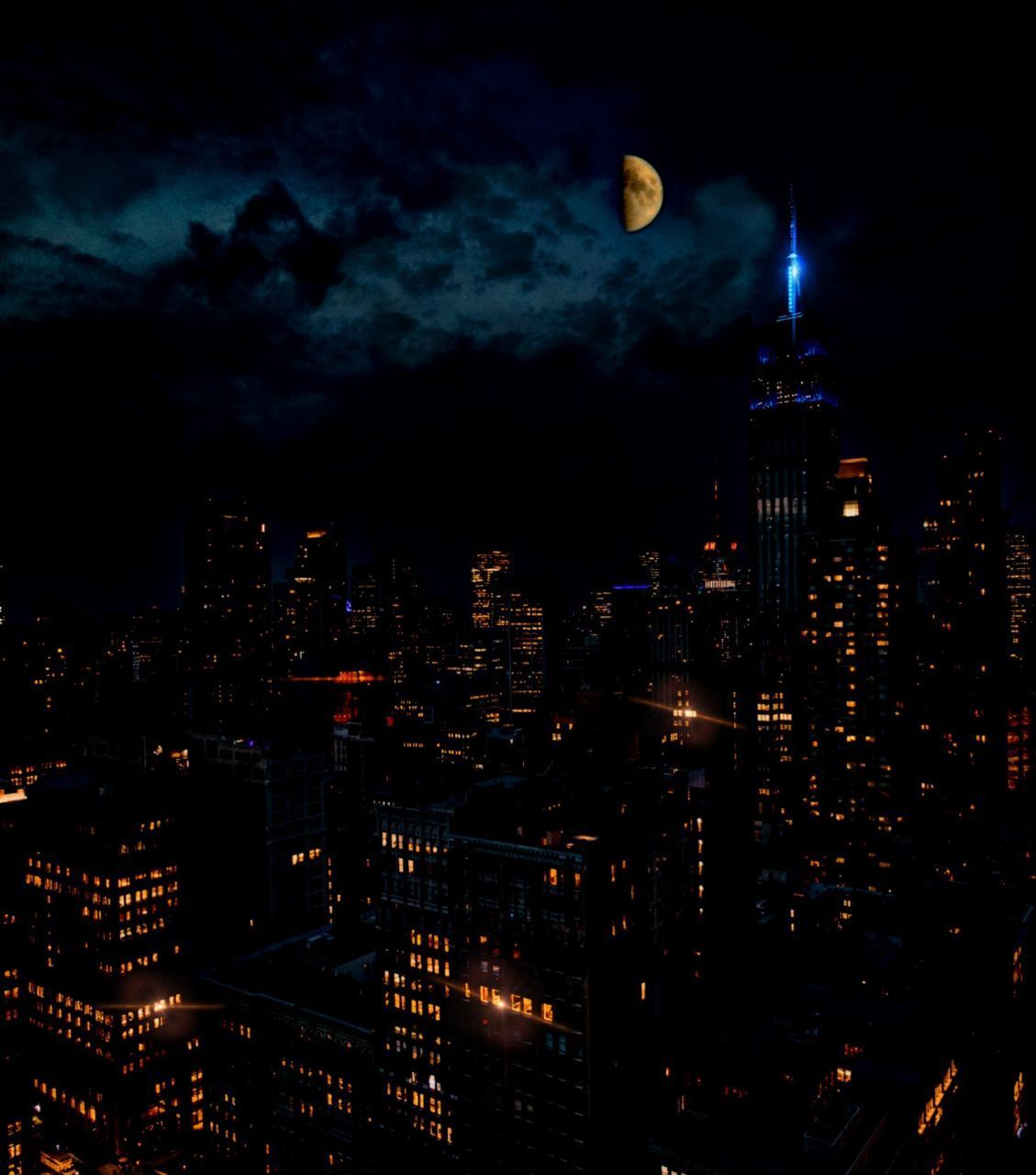 ILLUMINATED CITY AGAINST SKY AT NIGHT