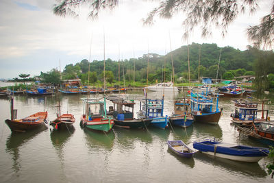 Boats moored in lake against sky