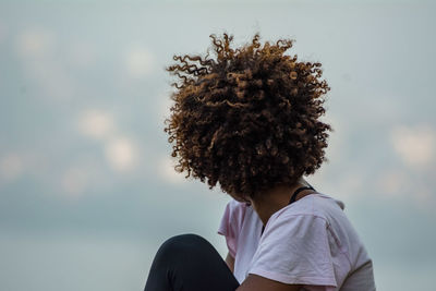 Side view of woman with curly hair