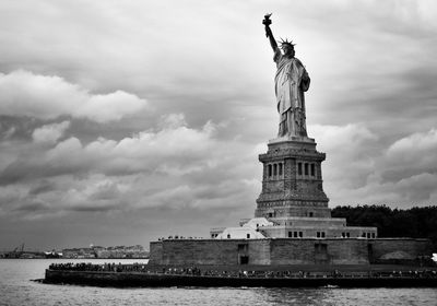 Statue of liberty against cloudy sky
